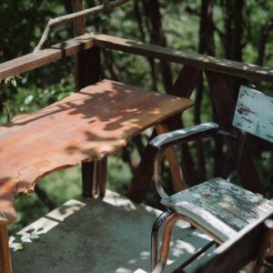 Weathered wooden furniture in an outdoor courtyard